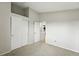 Neutral bedroom with vaulted ceilings features a closet and door to the utility room at 1978 Newland Ct, Lakewood, CO 80214