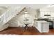 Bright dining area with hardwood floors, a staircase, and easy access to the kitchen at 1978 Newland Ct, Lakewood, CO 80214
