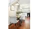 Dining area features hardwood floors, modern table and chairs, and kitchen with white cabinets at 1978 Newland Ct, Lakewood, CO 80214