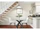 Cozy dining area under stairs, featuring a glass table and comfortable seating at 1978 Newland Ct, Lakewood, CO 80214
