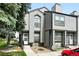 Well-maintained home has gray siding, landscaping, a stairway, and private front porch at 1978 Newland Ct, Lakewood, CO 80214