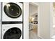 Laundry room with stackable washer and dryer near a cozy bedroom at 1978 Newland Ct, Lakewood, CO 80214