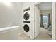 A convenient stacked washer and dryer unit is found in the home's laundry area at 1978 Newland Ct, Lakewood, CO 80214