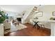 Cozy living room with fireplace, wood floors, and easy access to dining and kitchen area at 1978 Newland Ct, Lakewood, CO 80214