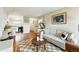 Bright living room featuring hardwood floors, modern furniture and decor and leads to the kitchen at 1978 Newland Ct, Lakewood, CO 80214