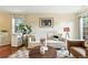 Comfortable living room with a couch, area rug, decorative house plant, and ample natural light at 1978 Newland Ct, Lakewood, CO 80214
