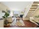 Spacious living room with a fireplace, staircase, modern furniture, and hardwood flooring at 1978 Newland Ct, Lakewood, CO 80214