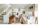 Inviting living room with hardwood floors, comfortable seating, and a staircase at 1978 Newland Ct, Lakewood, CO 80214