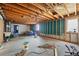 Unfinished basement with exposed wood beams, concrete floors, and rough-in plumbing at 1573 S Dexter Way, Denver, CO 80222