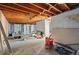 Unfinished basement space with exposed wood ceiling at 1573 S Dexter Way, Denver, CO 80222
