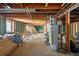 Unfinished basement with exposed wood beams and water heater at 1573 S Dexter Way, Denver, CO 80222