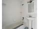 White bathroom with subway tile, classic pedestal sink, and some renovations needed at 1573 S Dexter Way, Denver, CO 80222