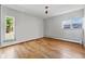 Light-filled room with beautiful hardwood floors and natural light from two windows at 1573 S Dexter Way, Denver, CO 80222
