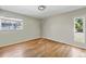 Cozy bedroom with hardwood floors and bright natural light from two windows at 1573 S Dexter Way, Denver, CO 80222