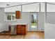 A bright kitchen featuring hardwood floors, stainless steel appliances and outdoor views at 1573 S Dexter Way, Denver, CO 80222