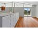 Bright living room with hardwood floors and a large sliding glass door with backyard views at 1573 S Dexter Way, Denver, CO 80222