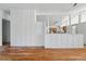 Spacious living area with hardwood floors and a white geometric cinder block half wall at 1573 S Dexter Way, Denver, CO 80222