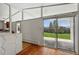 Living room featuring a large sliding door, hardwood floors, and large modern windows at 1573 S Dexter Way, Denver, CO 80222