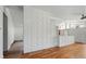Living room featuring hardwood floors, white cinder block wall and modern ceiling fan at 1573 S Dexter Way, Denver, CO 80222
