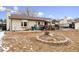 Spacious backyard showcasing a patio, deck, and outdoor seating areas, perfect for entertaining and enjoying the outdoors at 6718 Ingalls Ct, Arvada, CO 80003