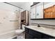 Functional bathroom features a shower-tub combination, vanity with sink, and built-in storage cabinet at 6718 Ingalls Ct, Arvada, CO 80003