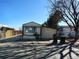 Exterior view of single-story home with a one-car garage and mature trees at 3241 E 84Th Dr, Thornton, CO 80229
