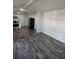 Spacious living room featuring wood-look flooring, white walls, and an open floor plan at 3241 E 84Th Dr, Thornton, CO 80229
