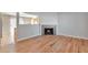 Living area with hardwood floors and a corner fireplace at 6441 S Eudora Way, Centennial, CO 80121