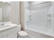 Clean bathroom with a shower and bathtub combination and white tile at 840 Leeward St, Lochbuie, CO 80603