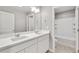Bathroom with double sink vanity, large mirror, and tile floors at 840 Leeward St, Lochbuie, CO 80603