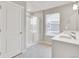 Bathroom featuring a glass enclosed shower, double sink vanity, and tile floors at 840 Leeward St, Lochbuie, CO 80603