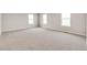 Spacious bedroom with neutral carpet and three bright windows at 840 Leeward St, Lochbuie, CO 80603