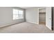 Bedroom featuring neutral carpet, a closet, and a large window at 840 Leeward St, Lochbuie, CO 80603