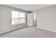 Bedroom with carpeted floors and a window overlooking the neighborhood at 840 Leeward St, Lochbuie, CO 80603