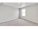 Bright bedroom with neutral carpet, light walls, and window at 840 Leeward St, Lochbuie, CO 80603
