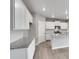 Bright kitchen features white cabinets, gray countertops and modern appliances at 840 Leeward St, Lochbuie, CO 80603