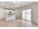 Open-concept kitchen with a granite island and sliding doors to the backyard at 840 Leeward St, Lochbuie, CO 80603