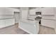 Modern kitchen with white cabinetry, granite countertops, and stainless steel appliances at 840 Leeward St, Lochbuie, CO 80603