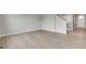 Entryway to a bright living area with hardwood floors and a staircase at 840 Leeward St, Lochbuie, CO 80603