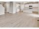 Bright, open-concept living space with hardwood floors and a modern kitchen at 840 Leeward St, Lochbuie, CO 80603