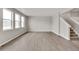 Spacious living area with hardwood floors and staircase to the upper level at 840 Leeward St, Lochbuie, CO 80603