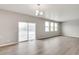 Spacious living area with hardwood floors and sliding glass doors to the backyard at 840 Leeward St, Lochbuie, CO 80603