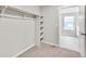 Walk-in closet featuring shelving and neutral carpet at 840 Leeward St, Lochbuie, CO 80603