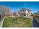 Spacious backyard with green grass, new fence, fresh landscaping, and trees at 5189 S Malta Way, Centennial, CO 80015