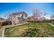 Inviting backyard featuring a lush lawn and young blossoming trees, perfect for outdoor activities and relaxation at 5189 S Malta Way, Centennial, CO 80015