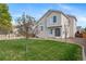 Spacious backyard featuring lush grass, beautiful trees, and a well-maintained fence for added privacy at 5189 S Malta Way, Centennial, CO 80015
