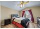 Bedroom with a ceiling fan, hardwood floors, and a window with red curtains at 5189 S Malta Way, Centennial, CO 80015