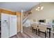 Open-concept dining area next to the kitchen with staircase and views of the second story at 5189 S Malta Way, Centennial, CO 80015