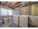 Basement laundry area featuring a washer, dryer, utility sink, and storage at 5189 S Malta Way, Centennial, CO 80015