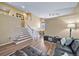 Bright and open-concept living area, with hard floors, stairs and a view of the dining area at 5189 S Malta Way, Centennial, CO 80015